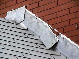 Roof flashing peeling away from brick.