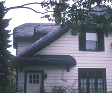 [Photo] The wood shingles on the roof of this Tudor Revival house were steamed and bent to resemble thatching.