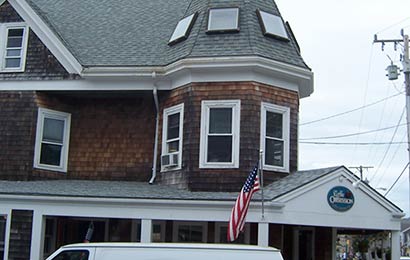 Commercial building with rounded turret at the corner and skylights installed in the roof of the turret.