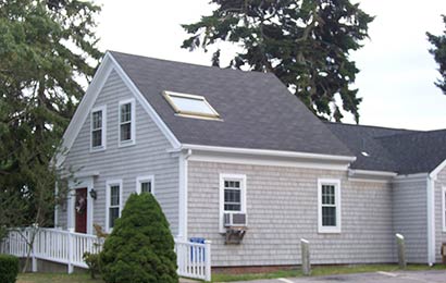 Small house with skylight installed in its gable roof.