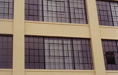 Multi-light metal windows after repair on a masonry building.