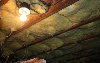 Batts of insulation installed between rafters in an attic.