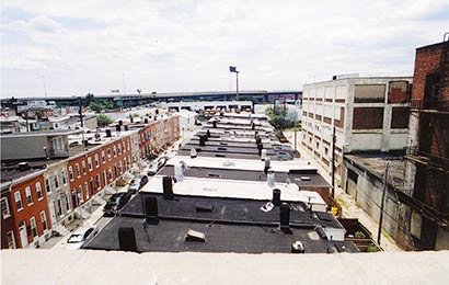 View across the flat roofs of rowhouses.