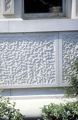 This is a detail image of decorative stone panels below a window sill on the main elevation of a historic building. The image rolls over to provide the correct answer. Screen Reader users see text-only link, left, for answer. Photo: NPS files.
