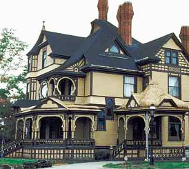 This is an image of a house with wood siding, shingles, cut outs, and applied ornamentation in the gable ends and on the porches. The contrasting paint colors create a dark and light pattern that also draws attention to the exterior materials. Photo: NPS files.