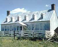 This is an image of a residential building with a steep roof and related features, such as the dormers and chimneys. Photo: NPS files.