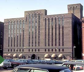 This is an image of a historic building with a distinctive, horizontal box-like shape with the middle portion projecting up an extra story. Photo: NPS files.