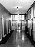 This is an image of an office building corridor with glazed walls, oak trim, and marble wainscotting, typical of those found in the late 19th and early 20th century office buildings.  Preserving corridors that display simple detailing, should be a priority in rehabilitation projects involving commercial buildings. Photo: NPS files.
