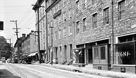 This is a 1936 image of 8010-8046 Main Street (Stone House Facades), Ellicott City, MD. Photo: HABS Collection, NPS.