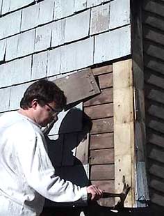 This is an image of a homeowner removing mid-20th century shingles to uncover 19th century clapboards. Physical and pictorial documentation will be used to consistently backdate the exterior appearance of the house to an earlier period. What is the treatment? Photo: John Leeke.