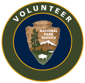 NPS Volunteer round logo with arrowhead graphic in the center