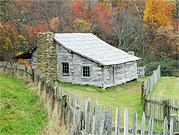 Weathered log cabins greet visitors to Hensley Settlement.