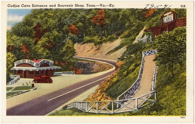 Postcard showing ticket office on a mountain road. On the card it reads, Cudjo cave entrance and souvenir shop Tenn, VA, KY