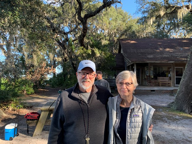 Jerry and Kirsten West standing near the Sea Camp Ranger Station