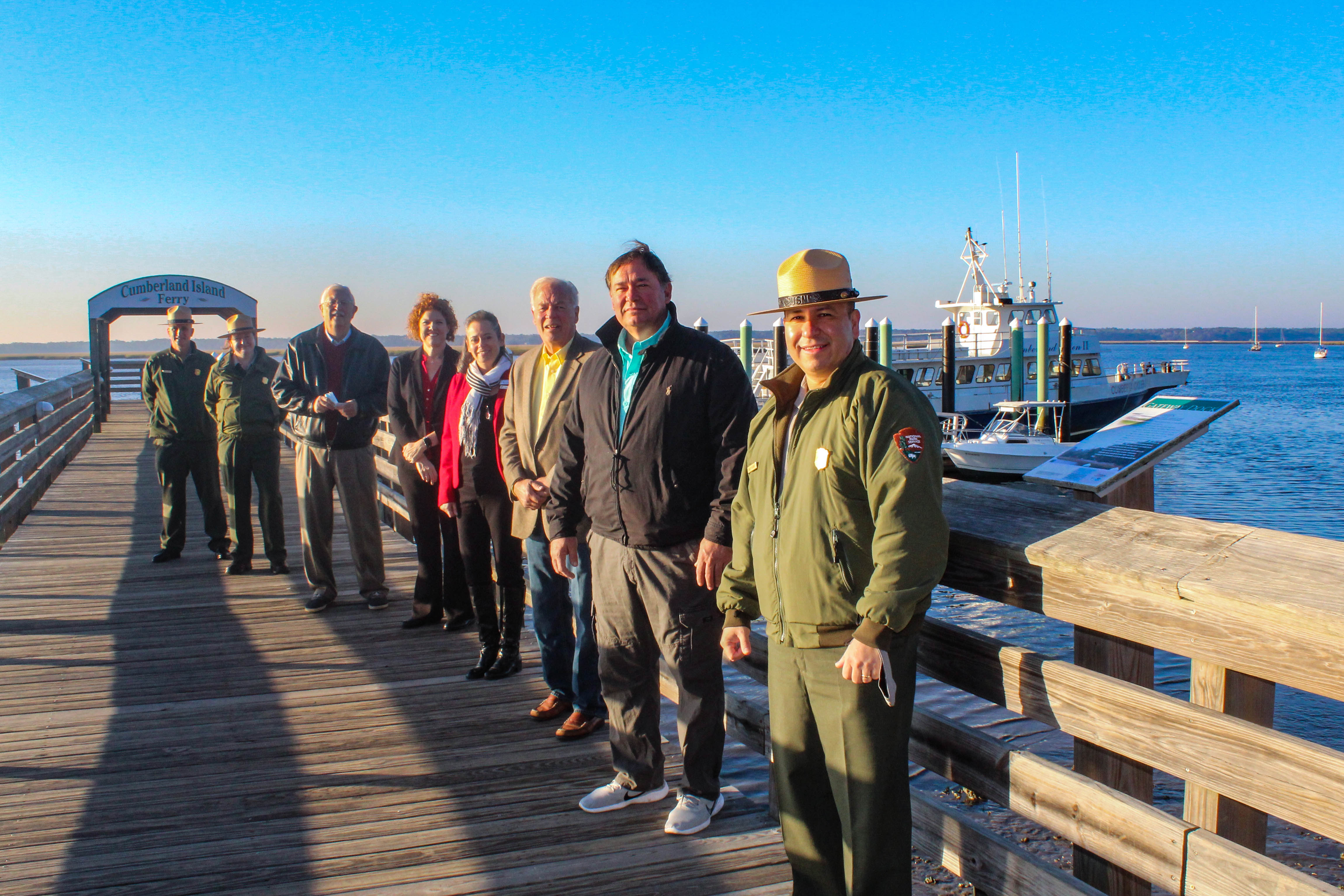 Group of people lined up on the dock with the cumberland ferry and st marys river in the background Group of people lined up on the dock with the cumberland ferry and st marys river in the background