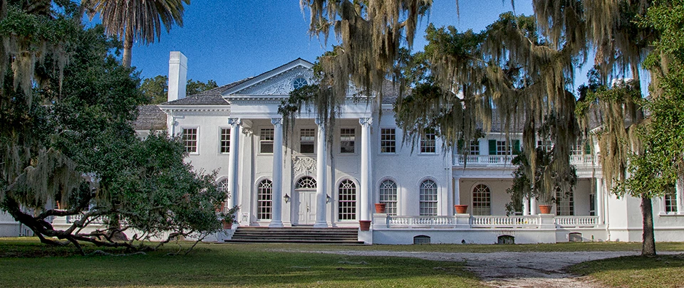 Plum Orchard Mansion white, Georgian Revival style mansion under blue skies