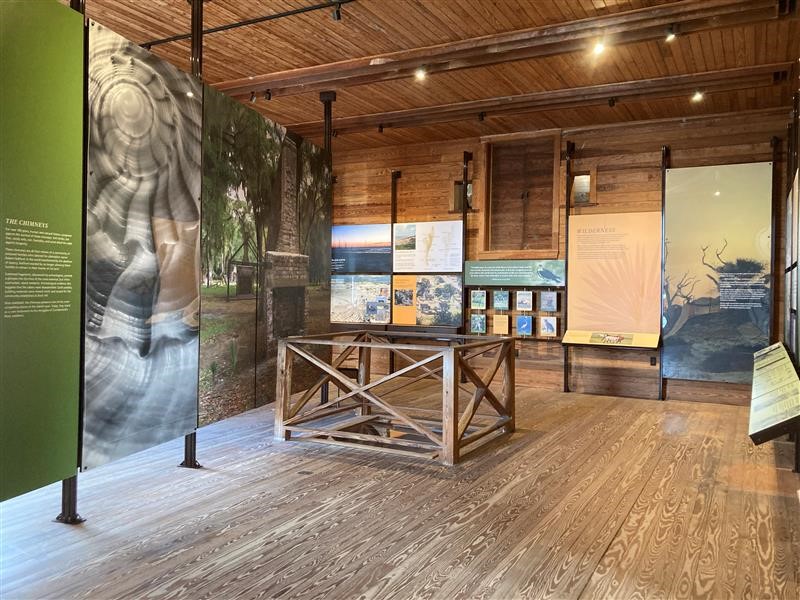 Exhibit panels inside the Ice House Museum showing images of various habitats and wildlife