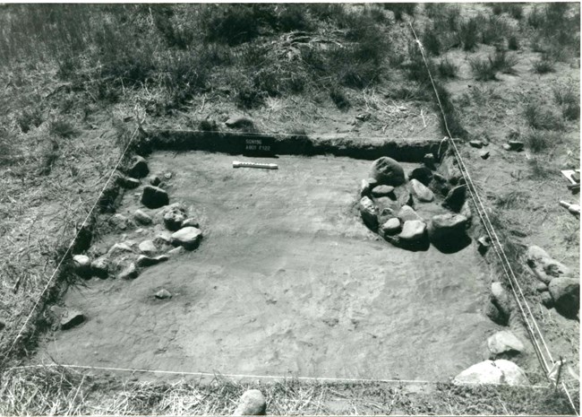Black and white image of two hearths inside a marked archeological survey site