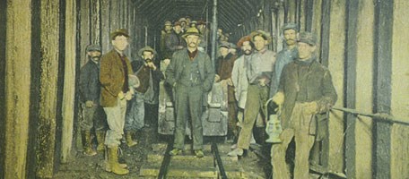 Gunnison tunnel workers with train car.