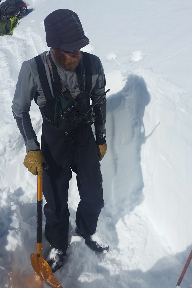 Digging a snow pit to look at the snow pack