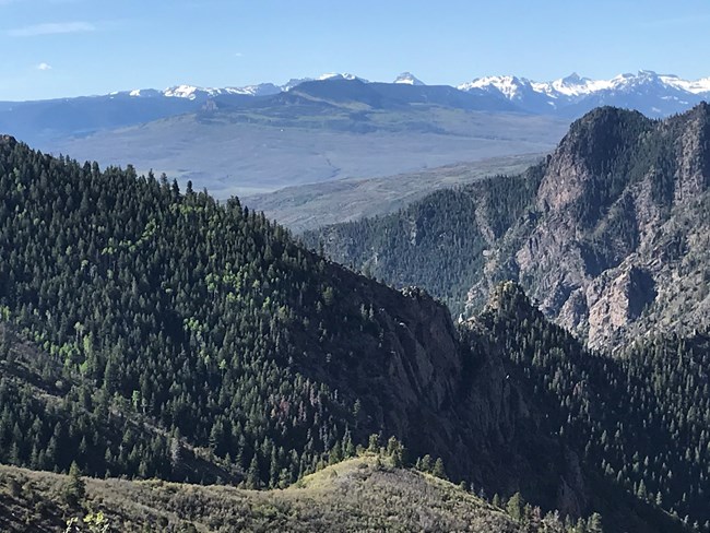Ridges along the Crystal Trail with the San Juan Mountain Range along the far horizon.