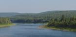 Wooded river with church along banks