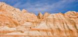 Badlands formations against the blue sky; photo by Rikk Flohr