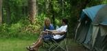 Campers relaxing at their site