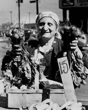 Black and white photo of a vendor selling beets at Cleveland's West Side Market, 1947.