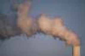 close-up photo of a smoke stack emitting dark smoke