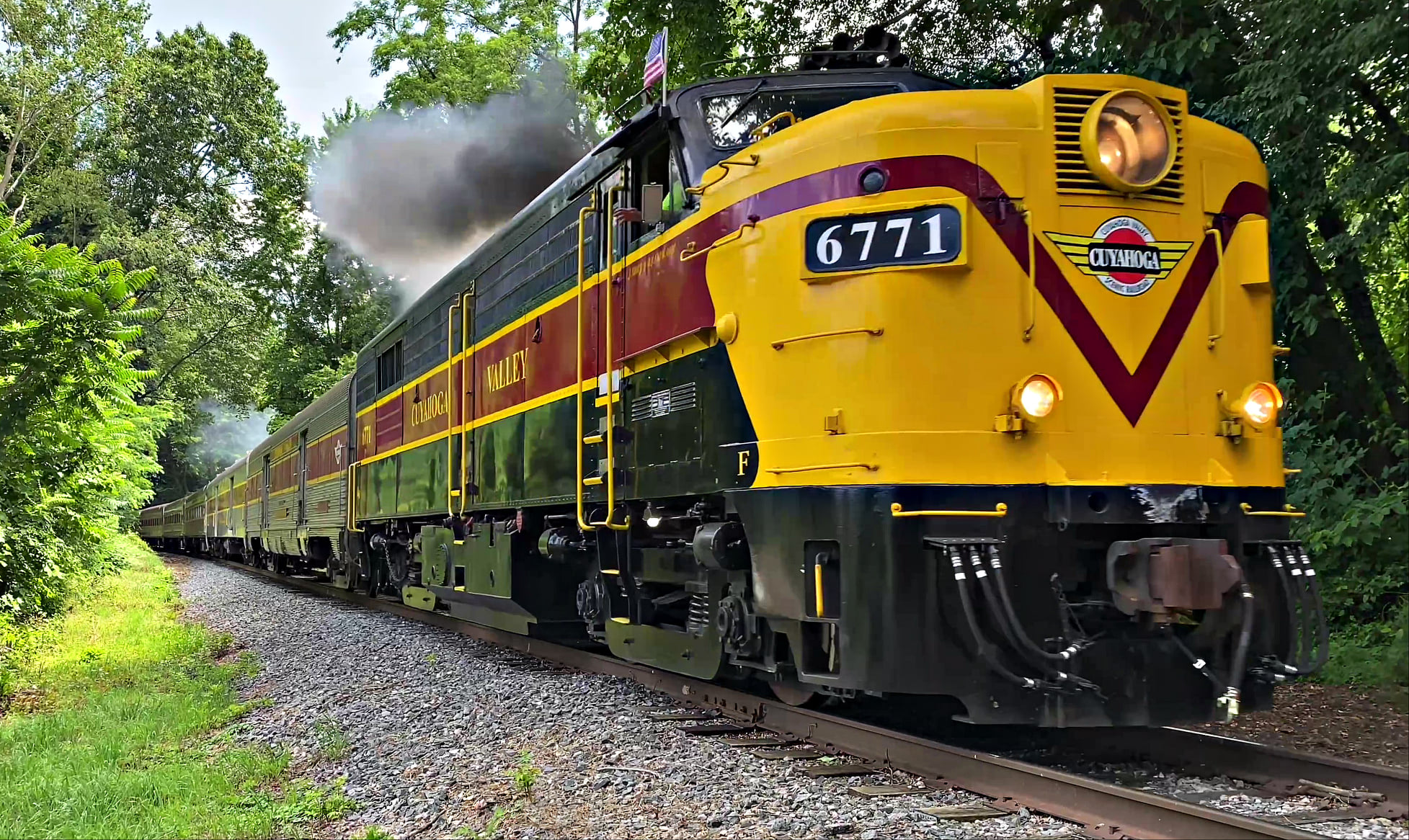 Cuyahoga Valley Scenic Railroad train on tracks surrounded by green foliage