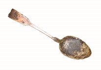 Close-up of a weathered metal spoon.