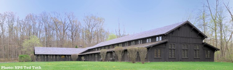 the large wooded Happy Days lodge in a grassy field the large wooded Happy Days lodge in a grassy field
