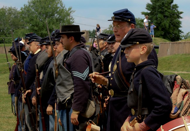 Union soldier re-enactors stand in a row Union soldier re-enactors stand in a row