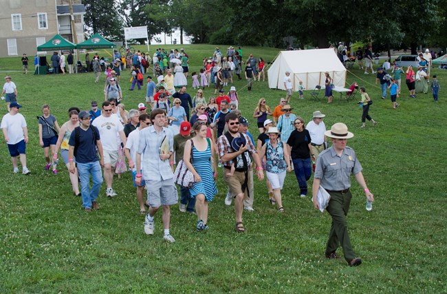 A park ranger is leading a group of visitors on an interpretation program. A park ranger is leading a group of visitors on an interpretation program.