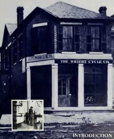 A large brick building and a small inset photo showing a man at a bench working