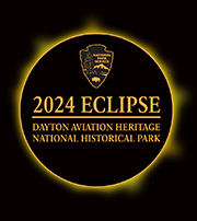 2024 Total Eclipse at DAAV NPS arrowhead and park name within a ring representing the eclipse.
