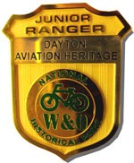 A gold Junior Ranger badge