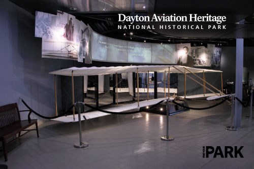 An early glider underneath a wide digital display board