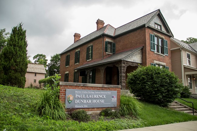 Image of the Paul Laurence Dunbar House showing the sign and NPS arrowhead.