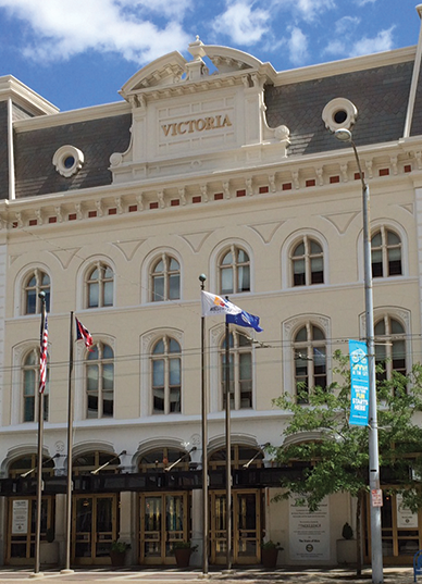 Flags flutter in the breeze outside the Victoria Theater.
