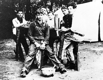 Six boys sitting at a camp table