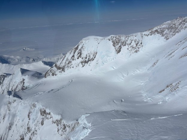 High altitude image of a snow covered mountain peak.