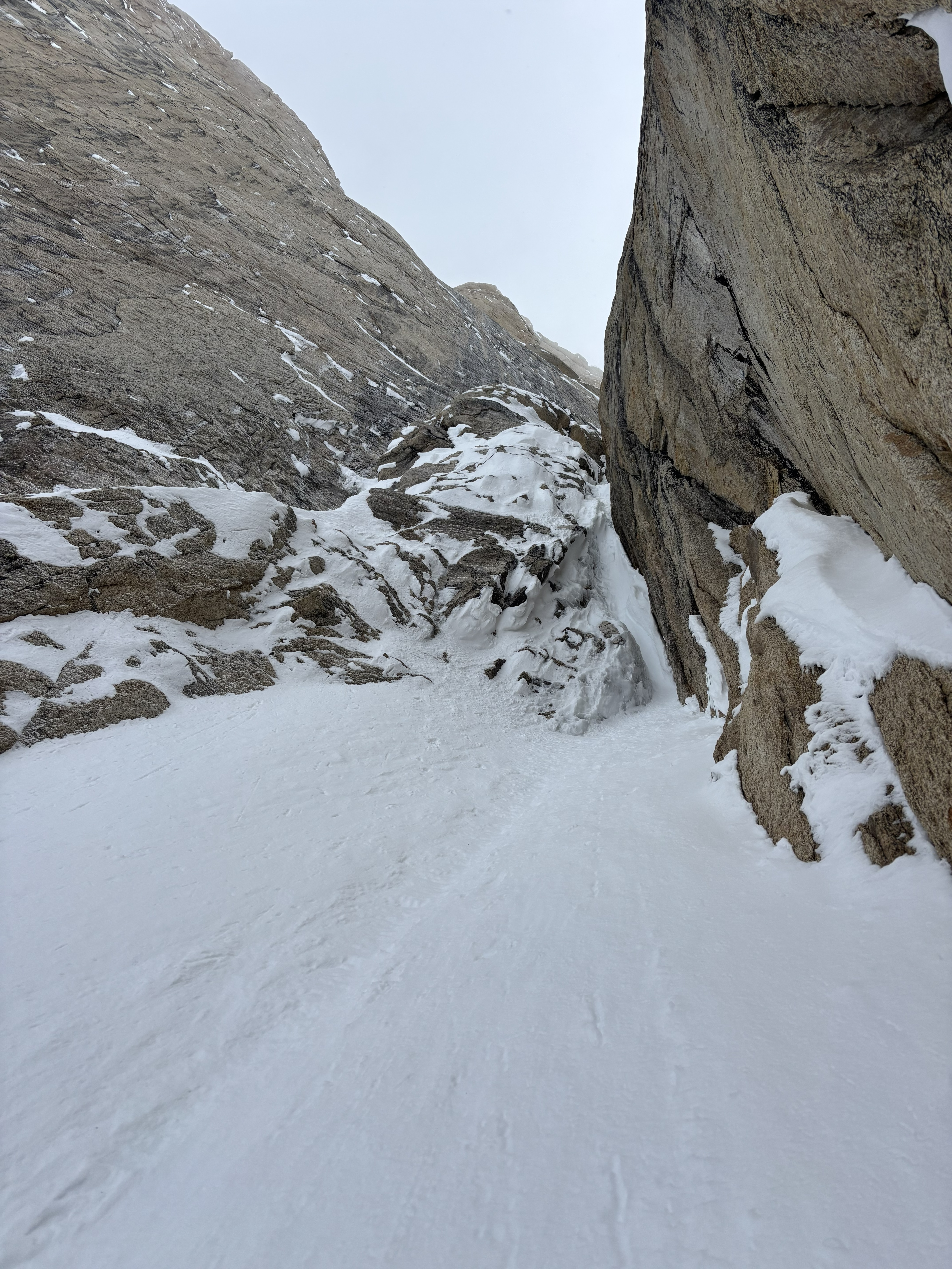 1st pitch of the upper choke Snowy landscape between two tall rock formations