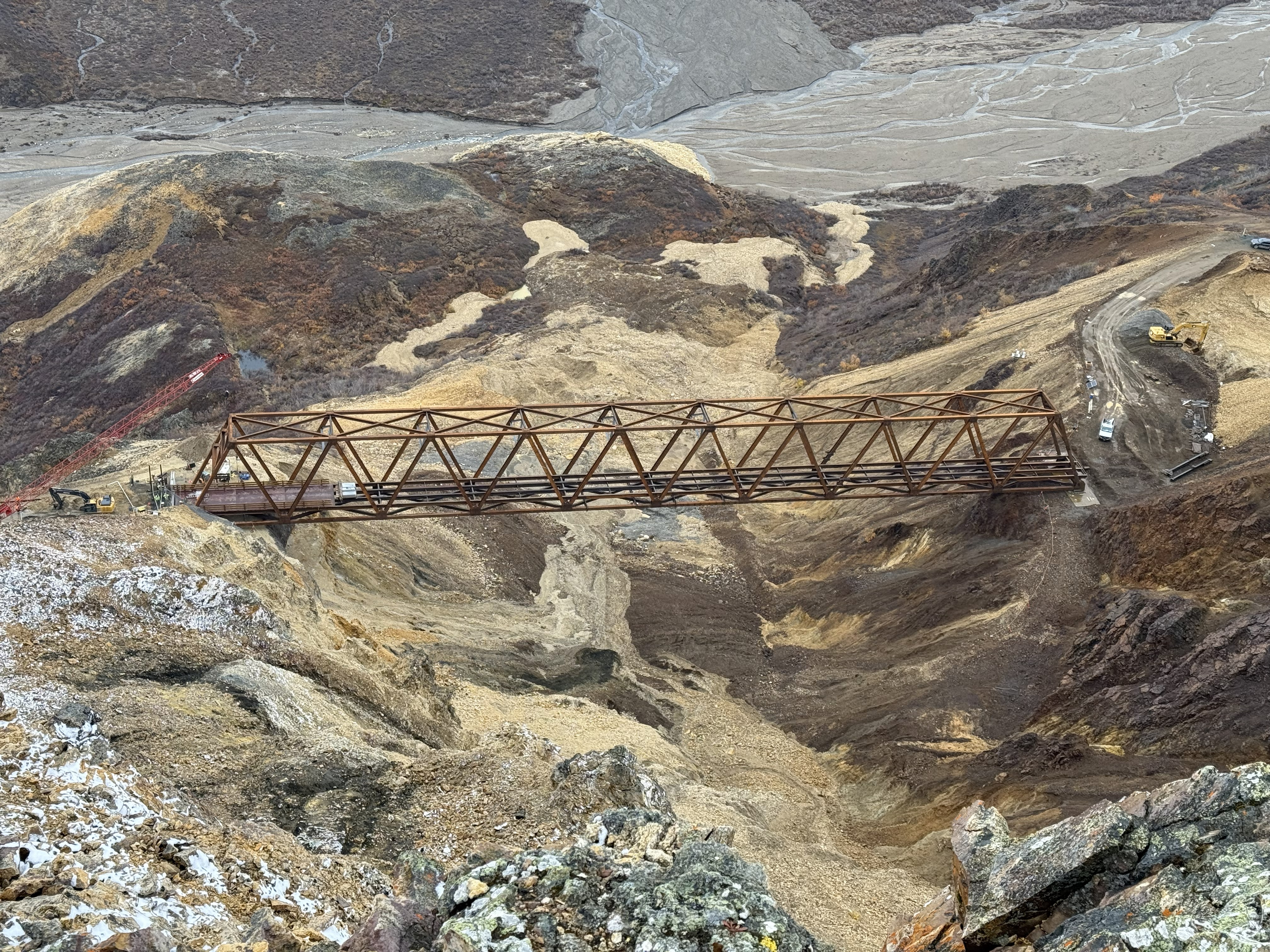 Looking down onto the Pretty Rocks bridge from the cliffs high above. The full truss of the bridge can be seen spanning the landslide.