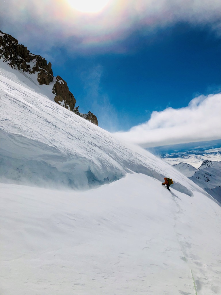 Mount Russell A climber ascends a snow slope in a light blowing mist