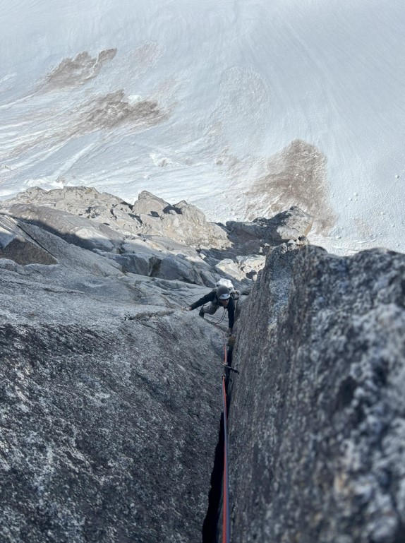 58 dihedral on the 5th pitch A ranger climbs up a rock face