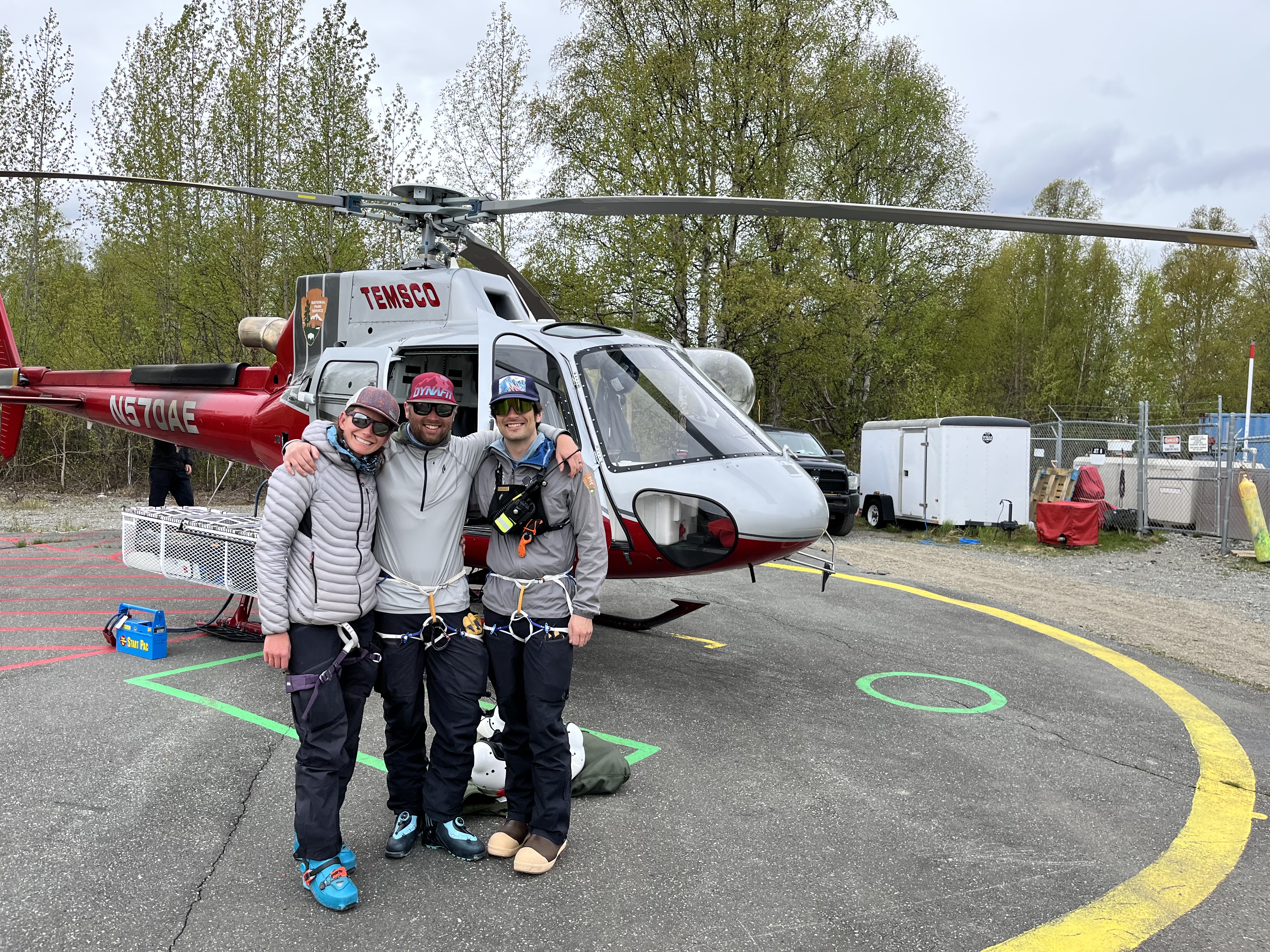 NPS Patrol - Ruth Gorge Three mountaineers stand outside a helicopter