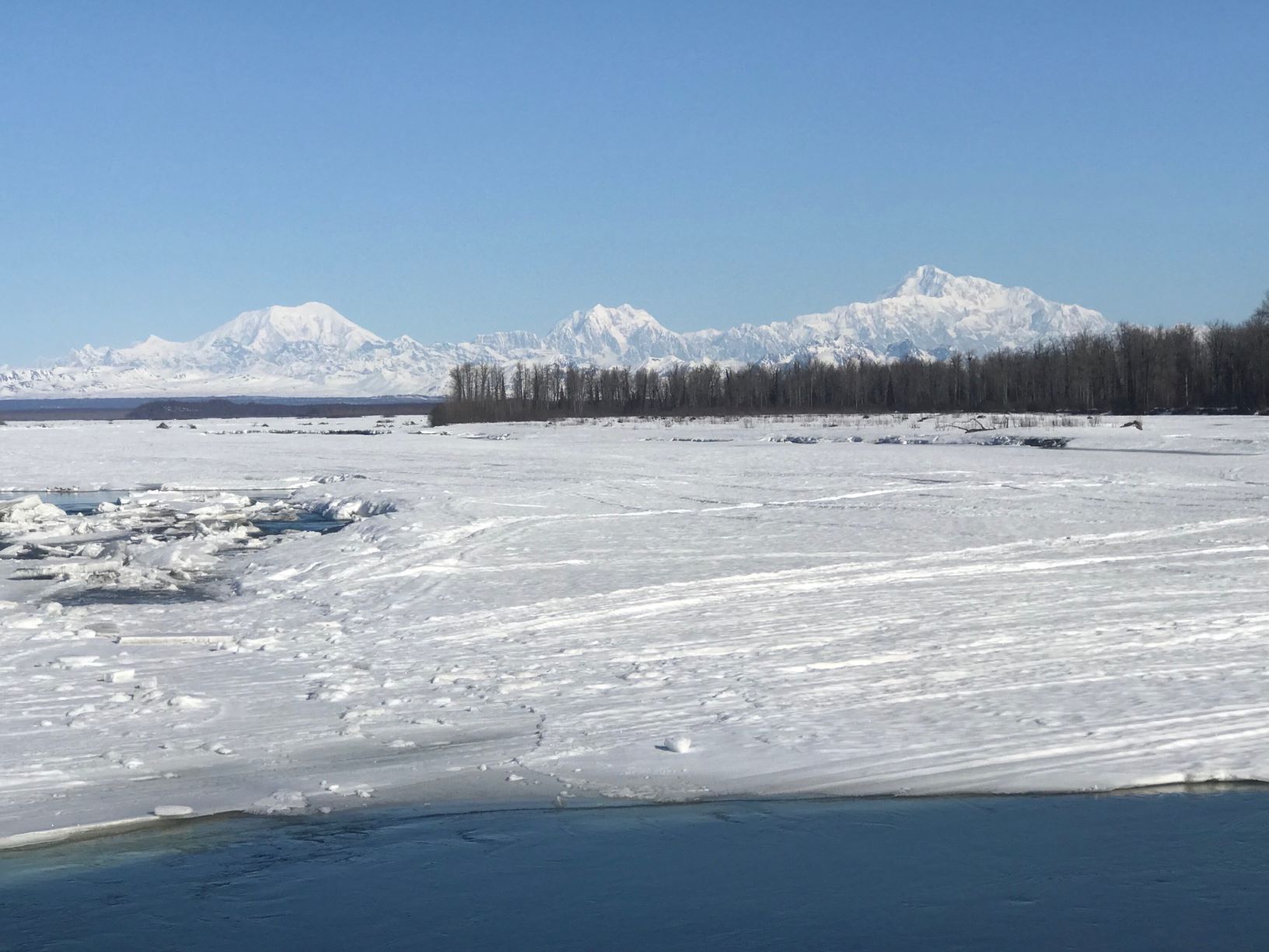 View of Mount Foraker, Hunter, and Denali from the still frozen Talkeetna River