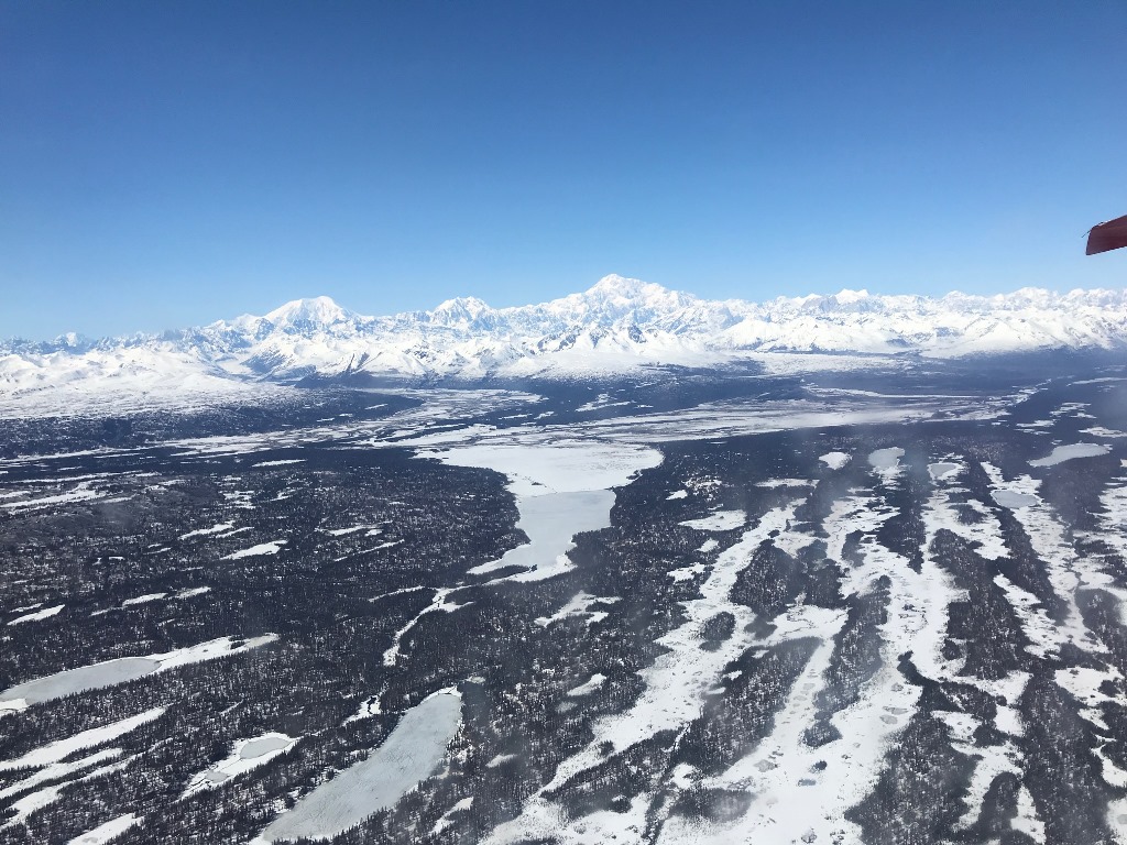 Expansive aerial view approaching the Alaska Range